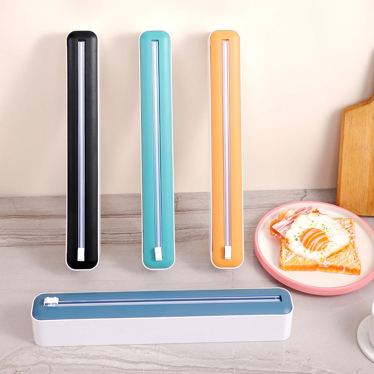 Household multi-functional cling film cutter, tear-free sliding cutter suitable for plastic cling film and aluminum foil.